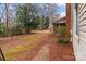 Spacious backyard featuring mature trees and a brick-lined walkway at 136 Coble Ave, Albemarle, NC 28001