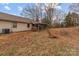 Expansive backyard featuring mature trees with a screened porch and siding at 136 Coble Ave, Albemarle, NC 28001