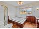 A bathroom featuring a large tub with wood trim, a toilet, and ample natural light at 136 Coble Ave, Albemarle, NC 28001