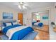 Bedroom with hardwood floors, decoratively wallpapered walls, ceiling fan, and cozy furniture at 136 Coble Ave, Albemarle, NC 28001