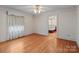 Bright bedroom with hardwood floors, ceiling fan and floral wallpaper at 136 Coble Ave, Albemarle, NC 28001