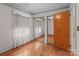 Bedroom with hardwood floors, decorative wallpaper, closet, and mirror adding visual interest at 136 Coble Ave, Albemarle, NC 28001