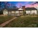 Charming single-story home with a brick chimney, accessible ramp, and welcoming front porch at 136 Coble Ave, Albemarle, NC 28001