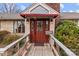 Inviting front entrance with a wooden ramp leading to the red door and awning above at 136 Coble Ave, Albemarle, NC 28001
