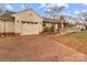 Home with attached garage and a brick driveway, featuring an accessible ramp at 136 Coble Ave, Albemarle, NC 28001