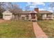 Charming home with accessible ramp, brick pathway, and well-manicured lawn at 136 Coble Ave, Albemarle, NC 28001