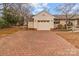 Attached garage with brick driveway and stylish exterior lighting at 136 Coble Ave, Albemarle, NC 28001