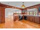 Vintage style kitchen with wooden cabinets, pink countertops, modern appliances, and an arch to the dining room at 136 Coble Ave, Albemarle, NC 28001