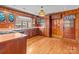 Vintage style kitchen with wooden cabinets, pink countertops, updated appliances, and door to backyard at 136 Coble Ave, Albemarle, NC 28001