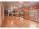 Large living room with hardwood floors, a fireplace, a ceiling fan, and windows with backyard views at 136 Coble Ave, Albemarle, NC 28001