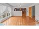 A spacious living room with hardwood floors, large windows and entry to the hall and a side door at 136 Coble Ave, Albemarle, NC 28001