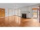 Open living area with hardwood flooring, fireplace, large windows, and smooth access to another room at 136 Coble Ave, Albemarle, NC 28001
