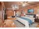 Spacious main bedroom features wood paneling, ceiling fan, and a decorative rug for added warmth at 136 Coble Ave, Albemarle, NC 28001