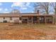 Back of house with a screened porch, a brick foundation and a large lawn at 136 Coble Ave, Albemarle, NC 28001