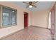 Cozy sunroom with mosaic tile floors, ceiling fan, and natural light from windows and door at 136 Coble Ave, Albemarle, NC 28001