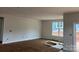 Bright, spacious living room with large window, fresh paint, and ample natural light at 140 First St, Huntersville, NC 28078