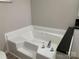 A large soaking tub with tile surround at 150 Twisted Oak Ln, Gastonia, NC 28052