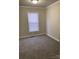 Cozy bedroom with neutral-colored walls, carpet, and a window at 150 Twisted Oak Ln, Gastonia, NC 28052