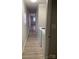 Hallway with light-colored walls, light wood flooring, and appliances at 150 Twisted Oak Ln, Gastonia, NC 28052