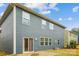 The backyard features a well-maintained lawn with blue siding, a patio, and lush greenery at 15119 Oleander Dr, Charlotte, NC 28278