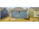 Exterior rear view of a two-story home with a lawn and small patio area at 15119 Oleander Dr, Charlotte, NC 28278
