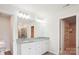 This bathroom features double sinks with granite counters, a large mirror, and a walk-in closet at 15119 Oleander Dr, Charlotte, NC 28278