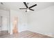 A bright bedroom features a ceiling fan, light wood floors, and two large closets at 15119 Oleander Dr, Charlotte, NC 28278