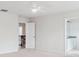 This bedroom features white walls, ceiling fan, and access to an ensuite bathroom with updated vanity at 15119 Oleander Dr, Charlotte, NC 28278