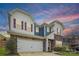 Charming two-story home featuring a brick facade, white siding, red shutters, and a convenient two-car garage at 15119 Oleander Dr, Charlotte, NC 28278
