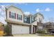 Charming two-story home boasts a stone facade, neutral siding, red shutters, and a spacious two-car garage at 15119 Oleander Dr, Charlotte, NC 28278