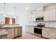 Modern kitchen boasts stainless steel appliances, granite countertops, and white cabinets at 15119 Oleander Dr, Charlotte, NC 28278