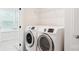 This modern laundry room features a large side-by-side washer and dryer plus plenty of shelf space at 15119 Oleander Dr, Charlotte, NC 28278