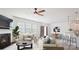Open-concept living room featuring a fireplace, dining area, and kitchen with bar seating at 15119 Oleander Dr, Charlotte, NC 28278