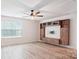 Upstairs bonus room with built-in entertainment center and hardwood floors at 15119 Oleander Dr, Charlotte, NC 28278