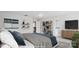 This staged main bedroom features decorative floating shelves, an entertainment center, and an ensuite bathroom at 15119 Oleander Dr, Charlotte, NC 28278