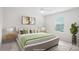 This is a virtually staged main bedroom featuring a large window and neutral decor at 15119 Oleander Dr, Charlotte, NC 28278
