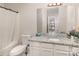Well-lit bathroom with granite countertops and shower-tub combination at 1751 Holliford Ct, Charlotte, NC 28215