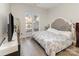 Comfortable bedroom features a large bed, lots of natural light, and wood-look flooring at 1751 Holliford Ct, Charlotte, NC 28215