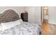 Large bedroom with wood-look floors and a view into the bathroom at 1751 Holliford Ct, Charlotte, NC 28215
