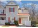 Inviting townhome with red accents, including shutters and a door, complemented by a well-maintained yard at 1751 Holliford Ct, Charlotte, NC 28215