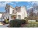 Side exterior view of a well-kept townhome featuring a charming porch and landscaped surroundings at 1751 Holliford Ct, Charlotte, NC 28215
