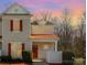 Charming townhouse with red door and trim, complemented by a well-maintained yard at 1751 Holliford Ct, Charlotte, NC 28215