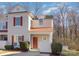 Attractive townhome showcasing a red metal roof, front yard bushes, and a welcoming red door at 1751 Holliford Ct, Charlotte, NC 28215