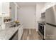 Modern kitchen with stainless steel appliances and light granite countertops at 1751 Holliford Ct, Charlotte, NC 28215