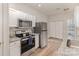 Well-equipped kitchen featuring white cabinets, stainless steel appliances, and granite countertops at 1751 Holliford Ct, Charlotte, NC 28215