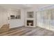 Bright living room features a fireplace, modern flooring, and an open view to the kitchen at 1751 Holliford Ct, Charlotte, NC 28215