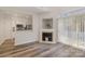 Bright living room showcases a fireplace, modern flooring, and an open view to the kitchen at 1751 Holliford Ct, Charlotte, NC 28215