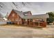 A brick home featuring an outdoor carport and concrete patio at 204 Julia Ave, Belmont, NC 28012