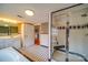 A tiled bathroom featuring a glass enclosed shower, bathtub and tiled floors at 204 Julia Ave, Belmont, NC 28012
