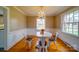 Bright dining room with stylish chandelier, round table, and ample natural light, ideal for Gathering meals and gatherings at 204 Julia Ave, Belmont, NC 28012